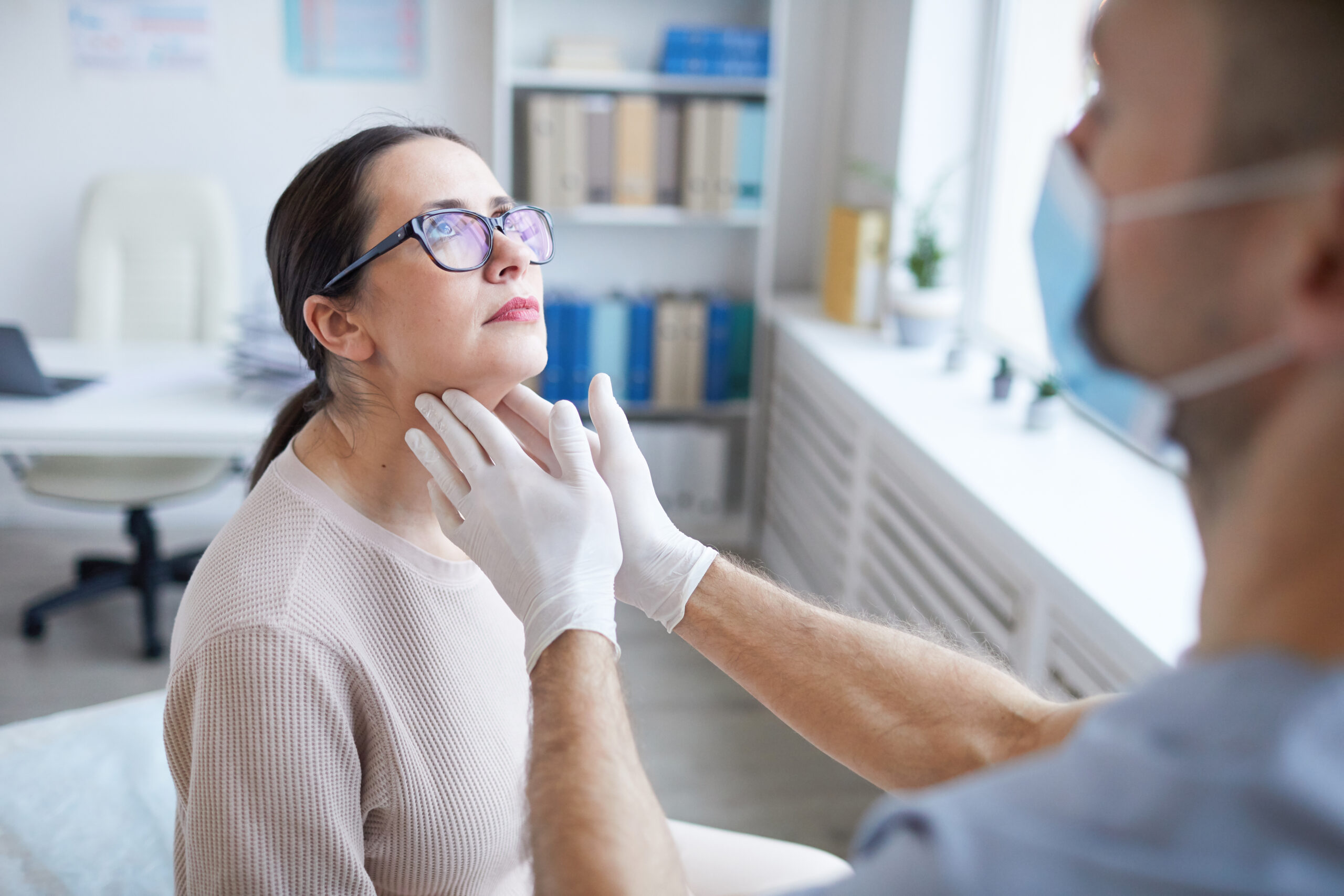 Doctor Examining Woman in Clinic